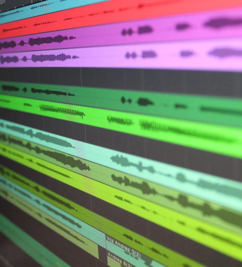 Close-up of audio waveforms in a multitrack session on a computer screen