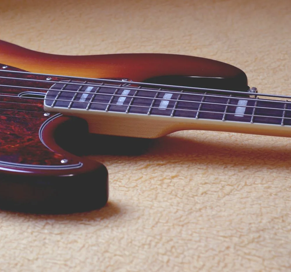 Close-up of the strings and body of an electric bass